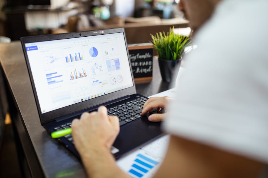Business analysis with graphs on laptop in modern office