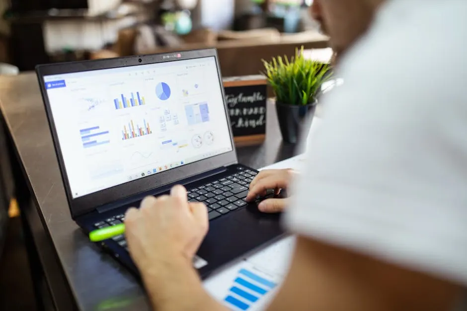 Business analysis with graphs on laptop in modern office